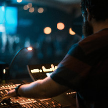 A man working with sound equipment during a church service.
