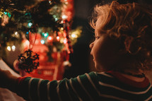 toddler decorating a Christmas tree 