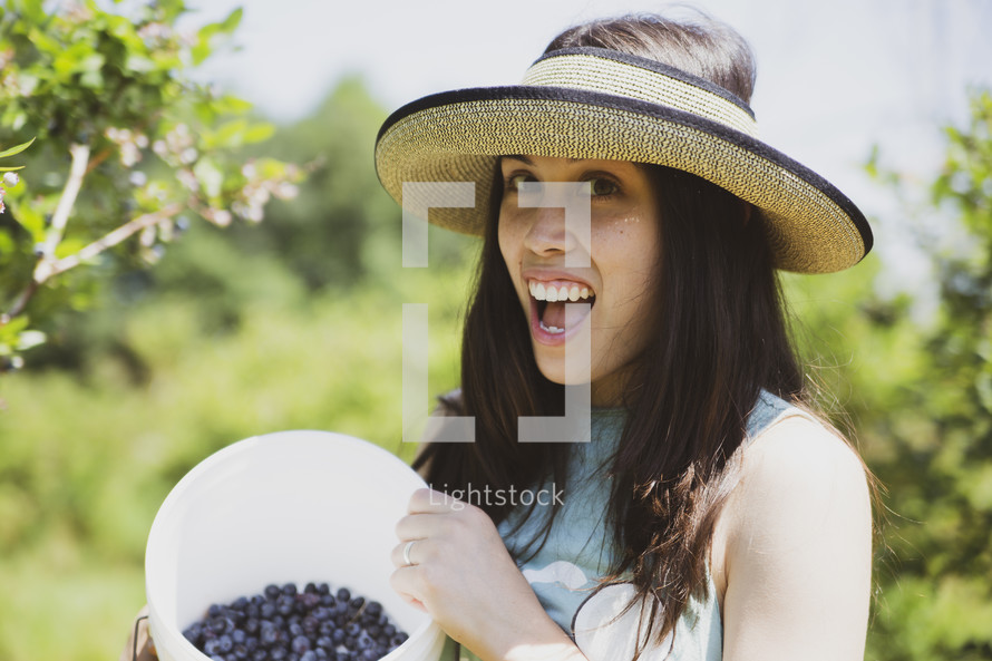 woman picking blueberries 