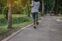 a woman jogging in a park 