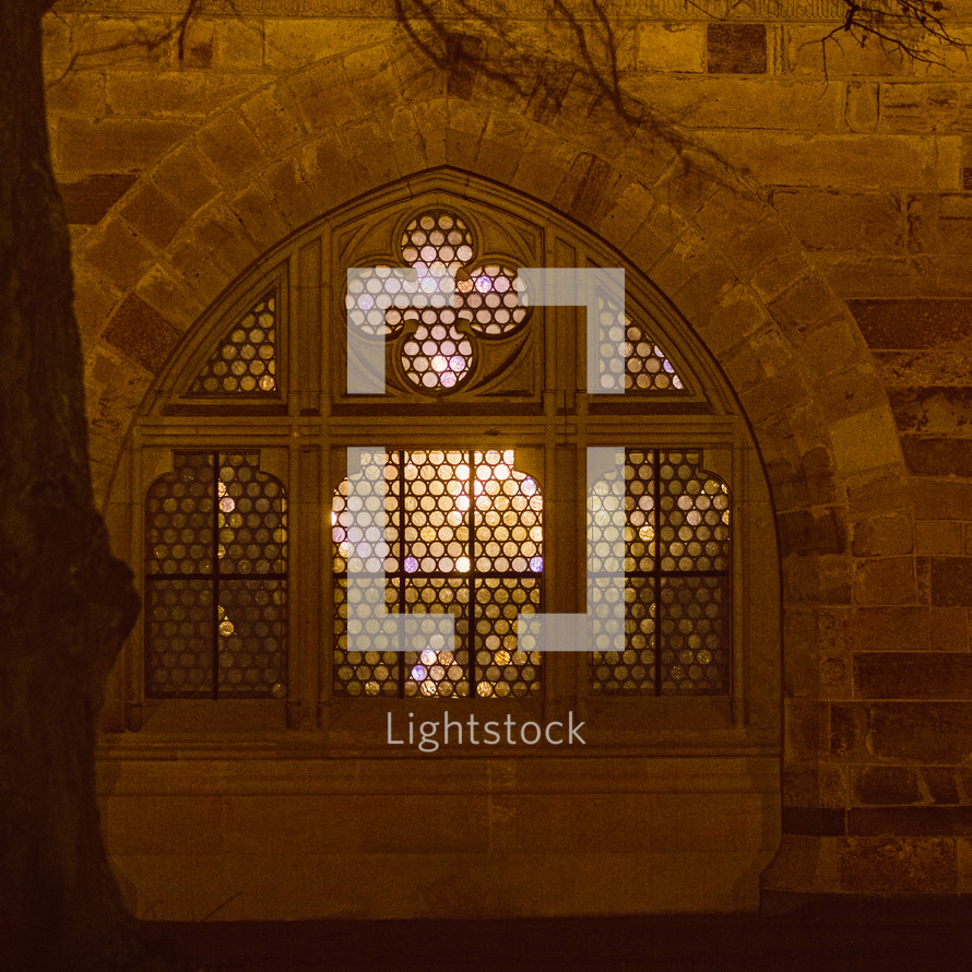 stone church window exterior at night 
