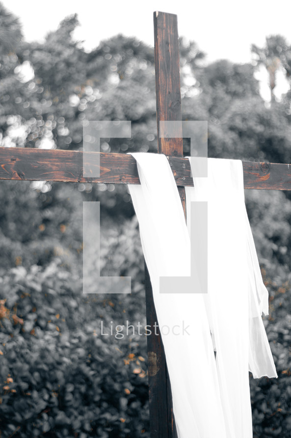 white shroud on a wooden cross 