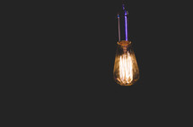 glowing Edison bulb in darkness 