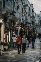 elderly men walking through a city 