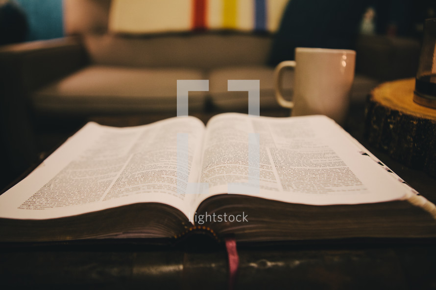 An open Bible on a coffee table. 