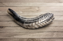 The Shofar on a wood background 