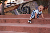 toddler boy climbing stairs