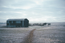 barn on a winter field 