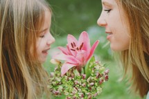 mother and daughter and a flower 