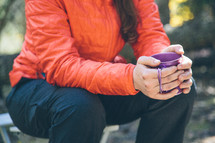 a woman camper drinking coffee from a mug