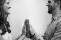 a couple making a promise to each other with their hands on a Bible 