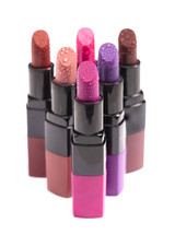 Multiple Tubes of Different Colored Lipsticks Isolated on a White Background