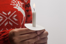 girl holding a candle at Christmas 