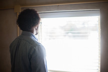 A man looking out a window 