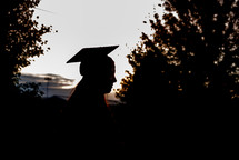 silhouette of a gradate in a cap and gown 
