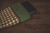 A Bible sticking out of a red and green stocking