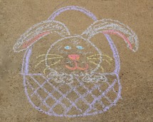 Easter bunny in an Easter basket drawing in sidewalk chalk 