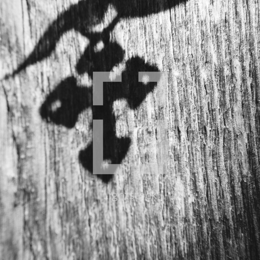 shadow of a cross on wood 