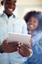 a couple looking at an iPad screen 