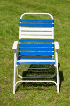 Lawn chair in the grass.