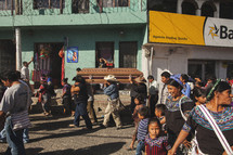 Men carrying a casket through a busy street 
