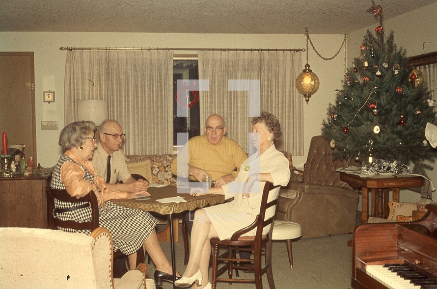 Grandparents sitting around a table at Christmas time 