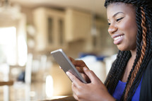 African American woman looking at an iPad screen 