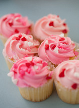heart shaped sprinkles on pink cupcakes for Valentine's day 