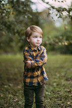 little boy standing outdoors 