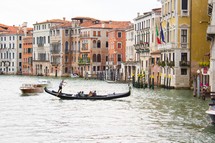 man padding a gondola in Venice 