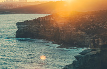 cliffs along a shore at sunset 