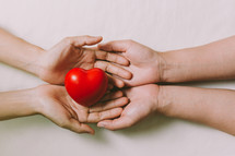 red heart in cupped hands 