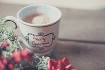 a Merry Christmas mug and holly 