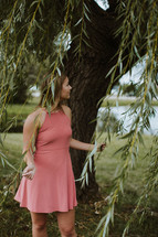 a woman holding weeping willow branches 