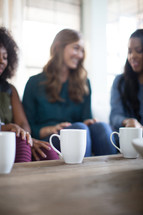 woman's group talking and drinking coffee 