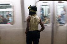 a woman waiting for a subway train 