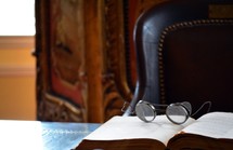 vintage spectacles on an open book 