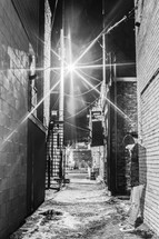 man standing in an alley