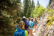 a group of people hiking on a trail 