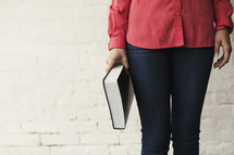 woman holding a Bible at her side 