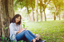 a student sitting in a park 