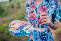woman holding an paint palette
