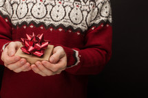 a man holding a Christmas gift box 