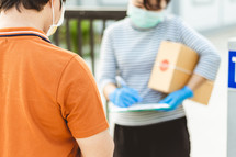 woman signing for a package 