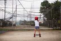 a girl in a batting cage 