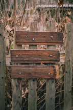 board boards nailed to a fence 