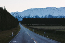 mountain road and snow capped mountain peaks 