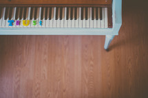 A piano keyboard with the word "trust" spelled out in colorful letters.