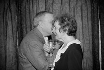 an elderly couple toasting on their anniversary 