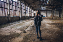 Young Girl with Mask in Empty Broken Factory Hall
